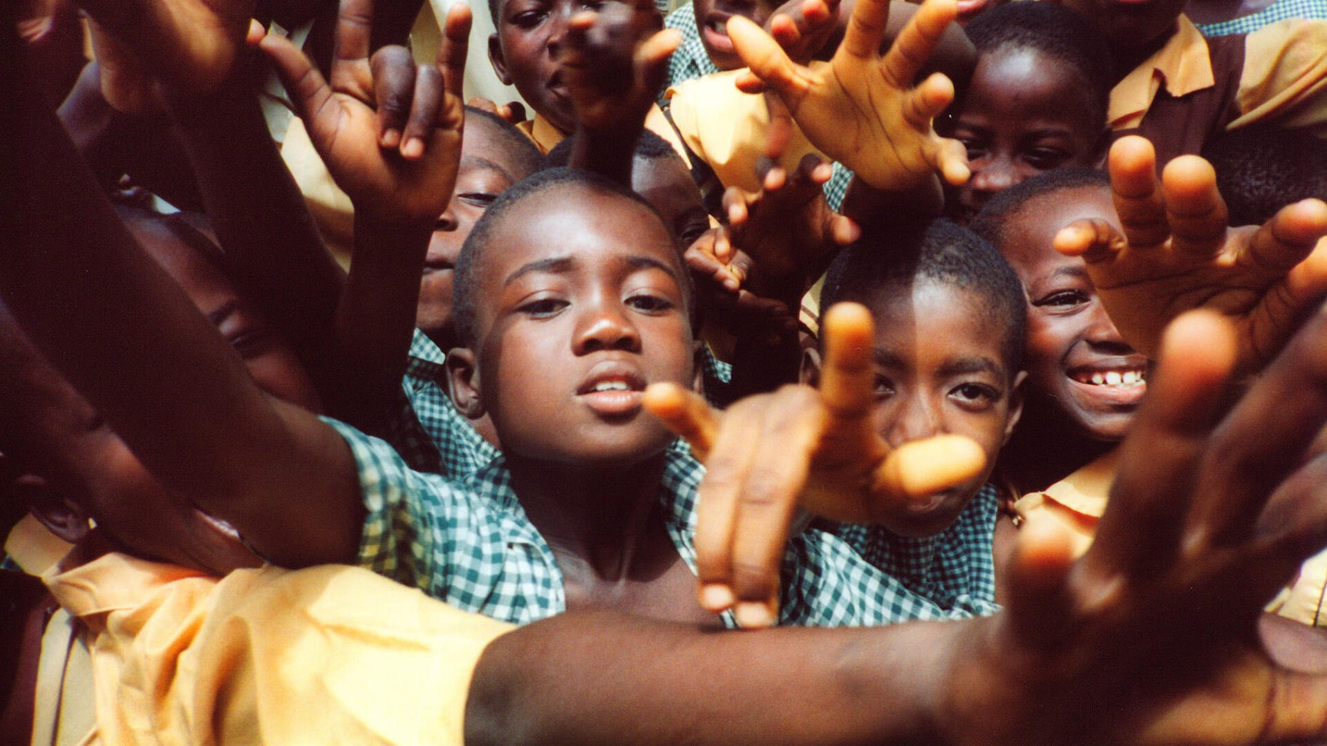Children reaching up with their hands raised at a Kidz Tour outreach